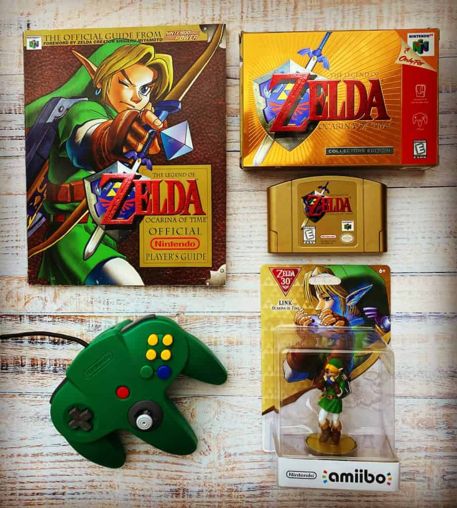 Zelda Ocarina of Time Collector's Edition box, cart, player's guide, amiibo, and green N64 controller