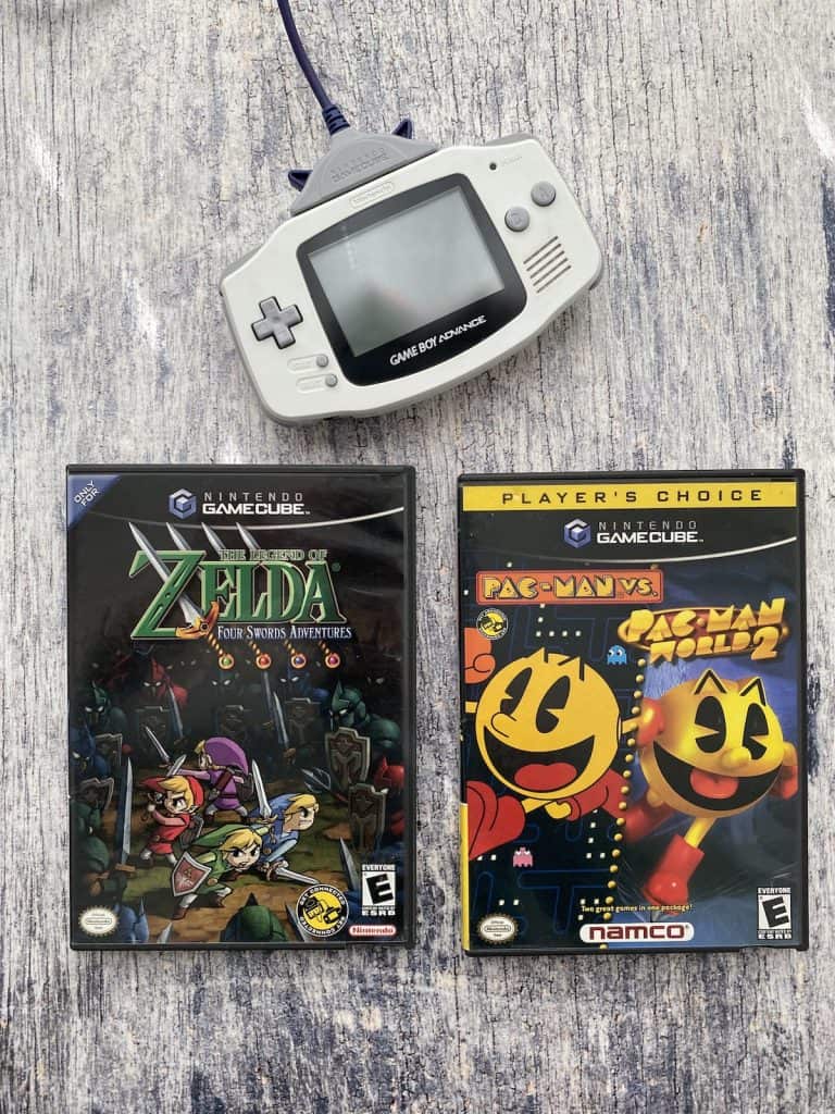 Game Boy Advance to GameCube connector with Game Boy Advance, Zelda Four Swords Adventures, and Pac Man Vs.