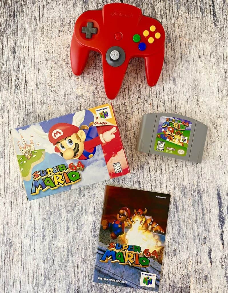 Super Mario 64 box, cart, manual, and red N64 controller