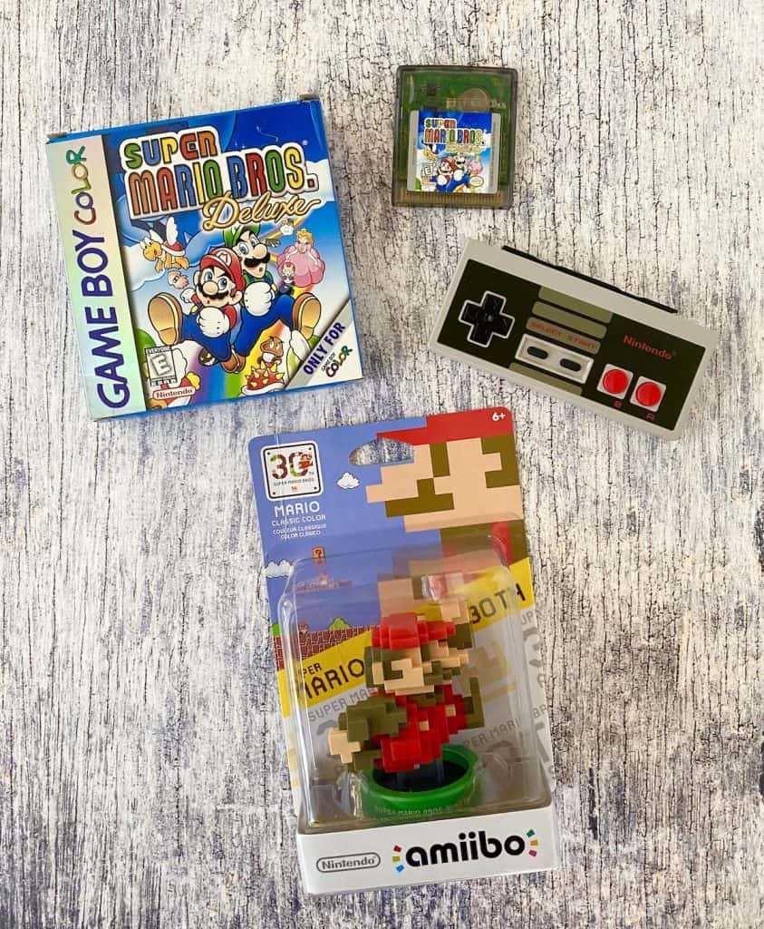 Super Mario Bros Deluxe for Game Boy Color box, cart, NES controller, and Mario 30th anniversary classic amiibo