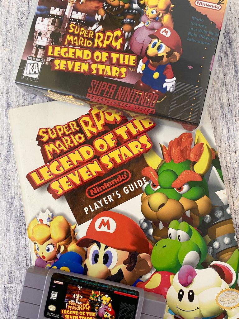 Super Mario RPG box, cart, and Nintendo Power player's guide