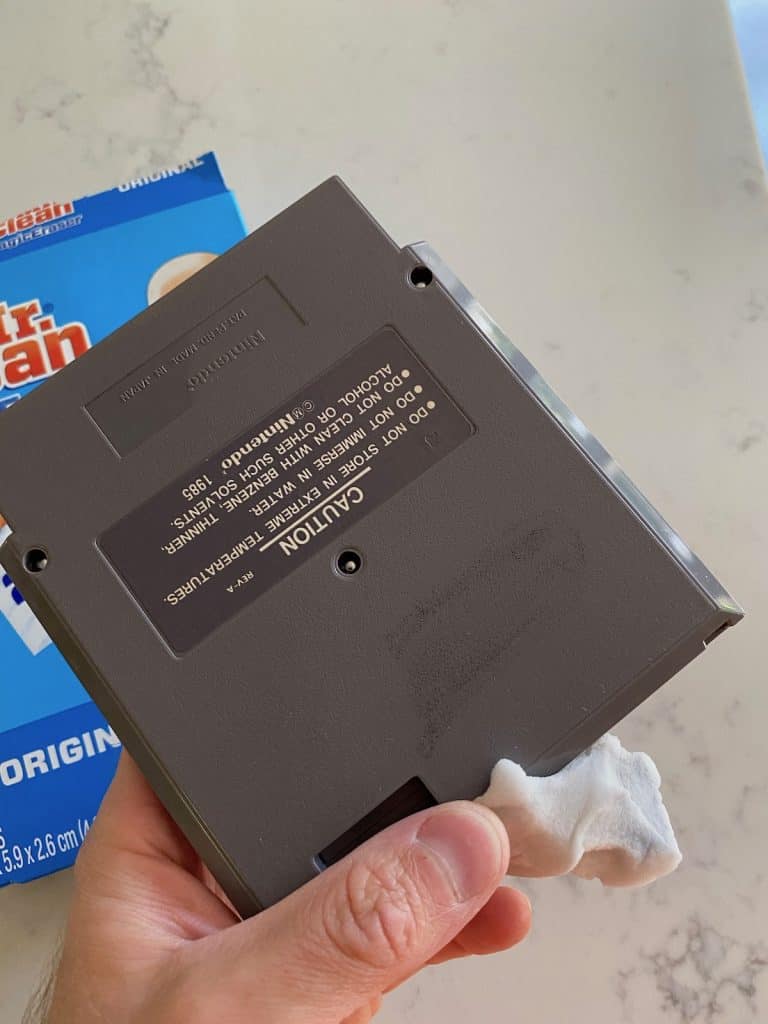 Scrubbing permanent marker off an NES cart using magic eraser, after 3 minutes or so