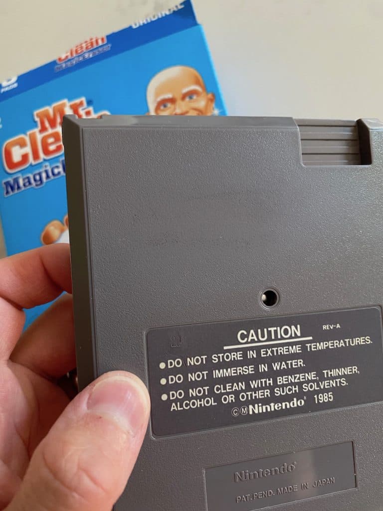 Scrubbing permanent marker off an NES cart using magic eraser, after 5 minutes or so