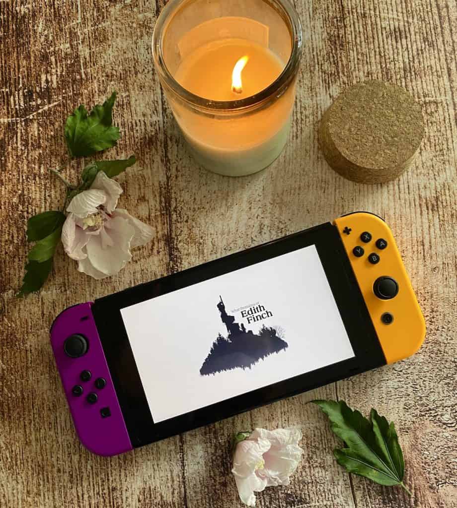 What Remains of Edith Finch title screen on Switch, surrounded by a lit candle and fallen leaves